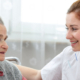 Caregiver helping female resident